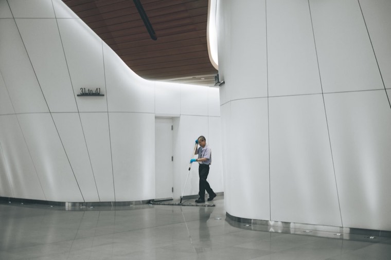 A Peache professional mopping a commercial building lobby